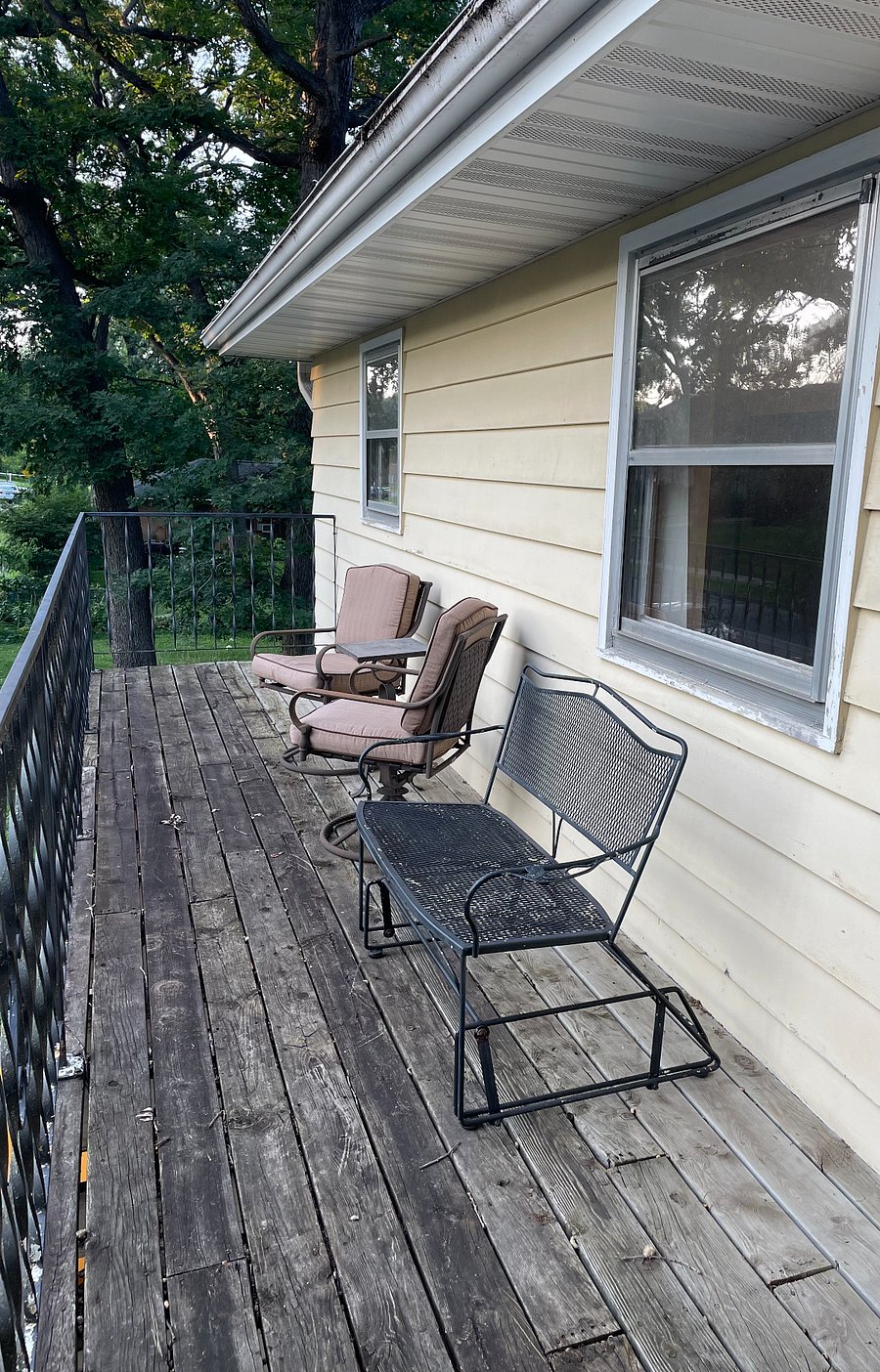 Large private deck with 2 chairs, small table, glider