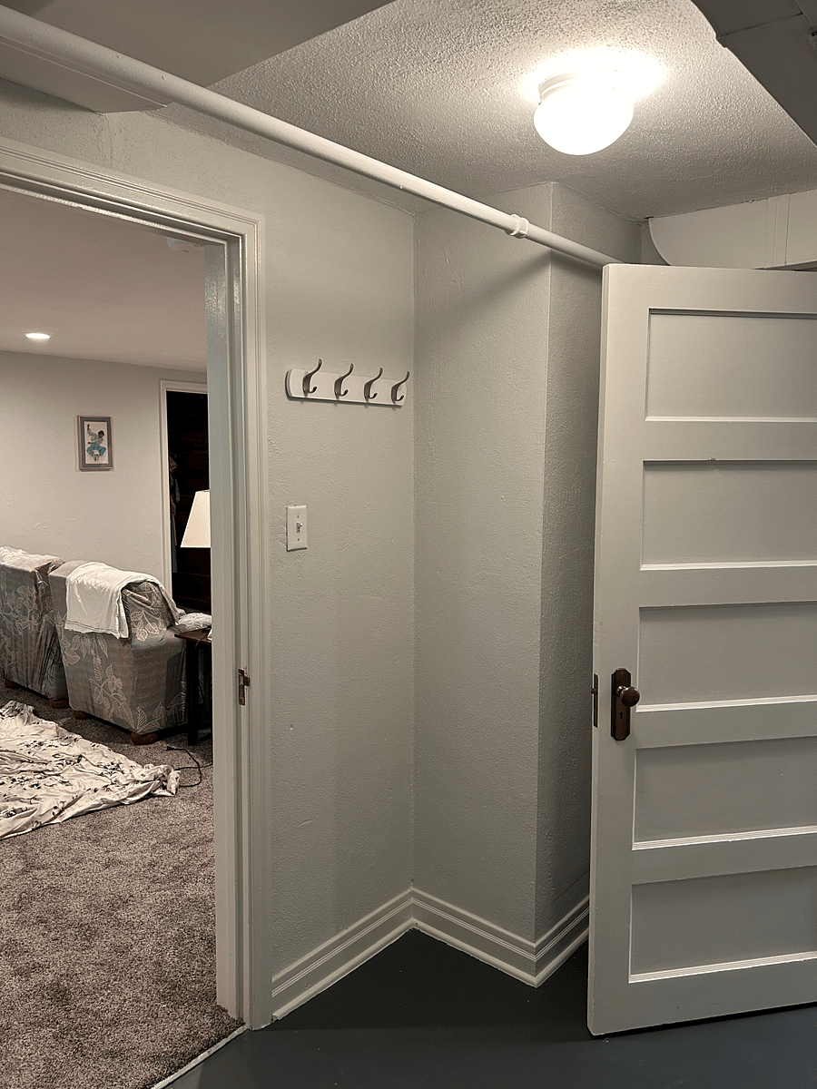 View from base of stairs into living/dining area. To the right is the kitchen entry.
