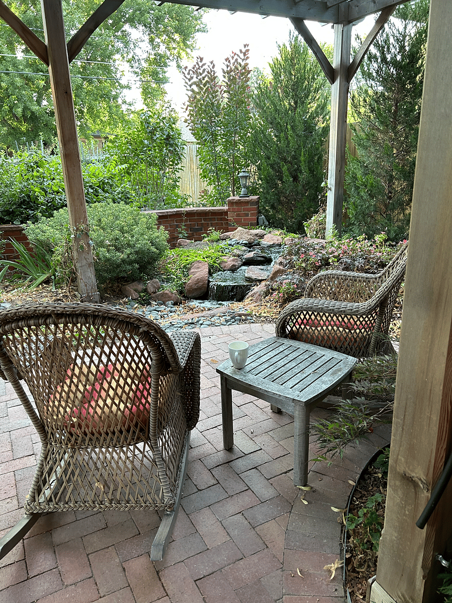 Backyard patio, water feature and sitting area by day