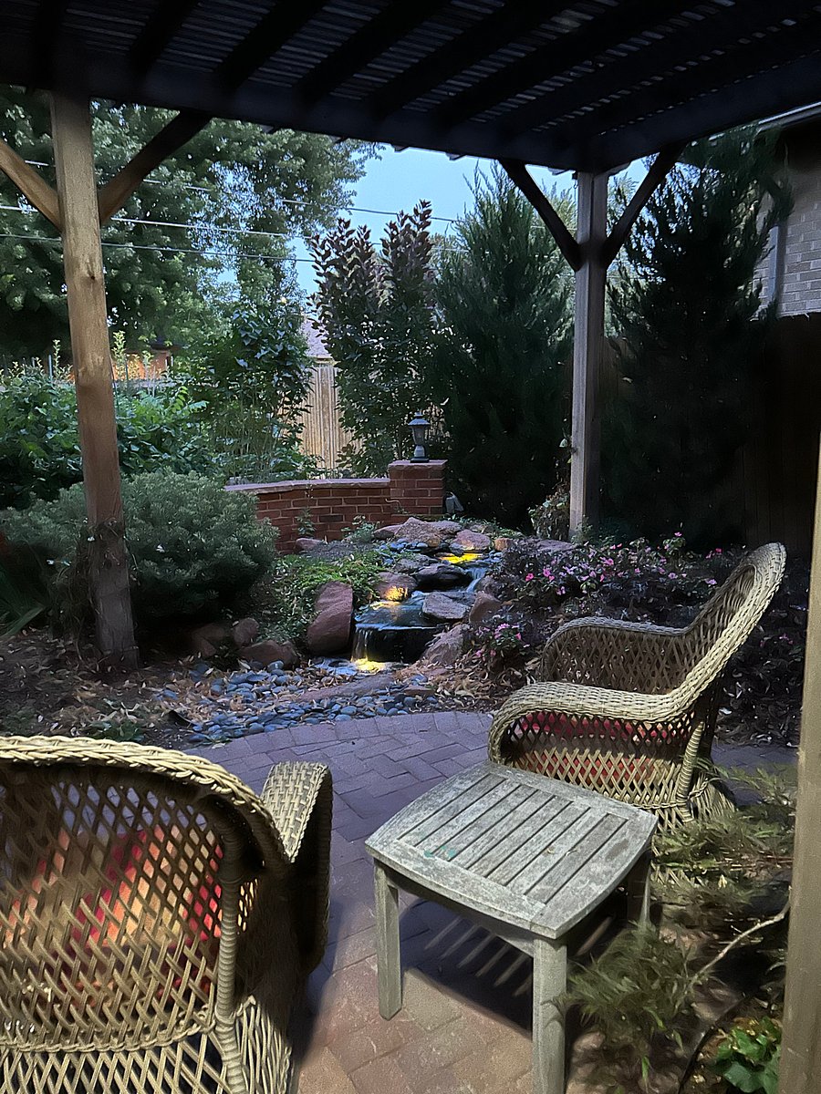 Backyard patio, water feature and sitting by night