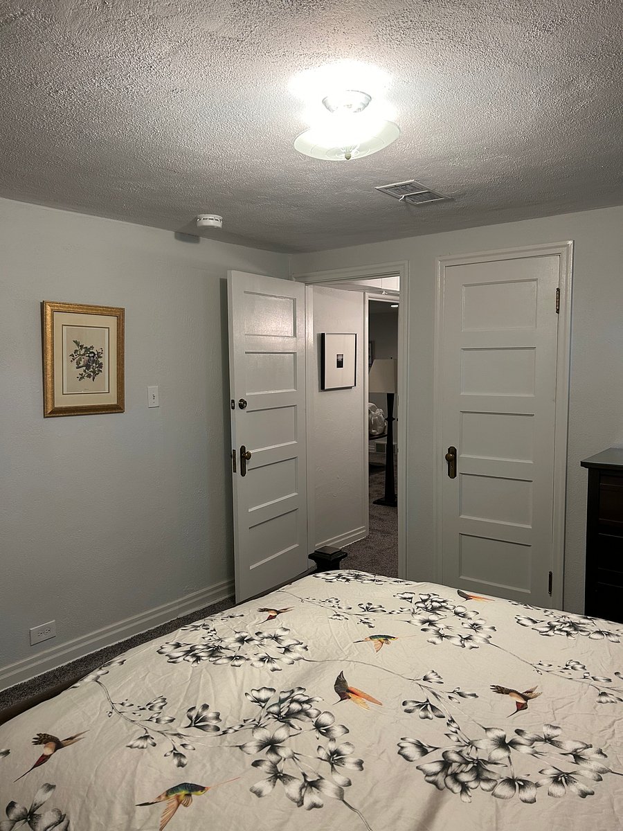East bedroom door, closet and view into back hall and living area