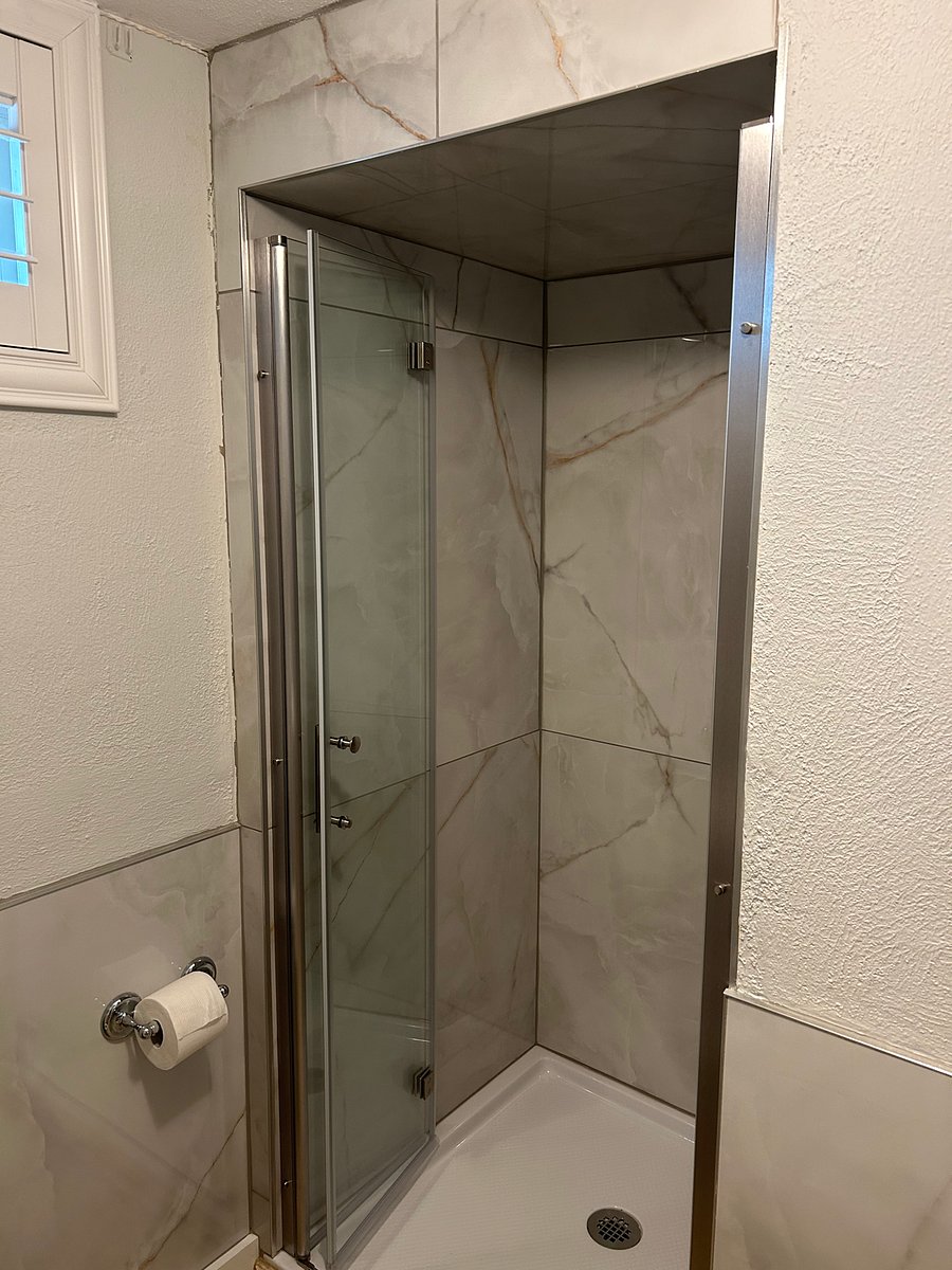 Shower with bi-fold glass door