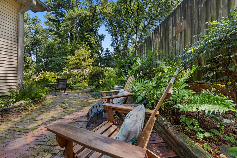 Outside seating and table for dining, enjoying the garden, or cozying up next to the fire pit.