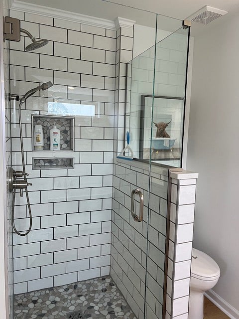 Custom built shower with dual shower heads in master bathroom