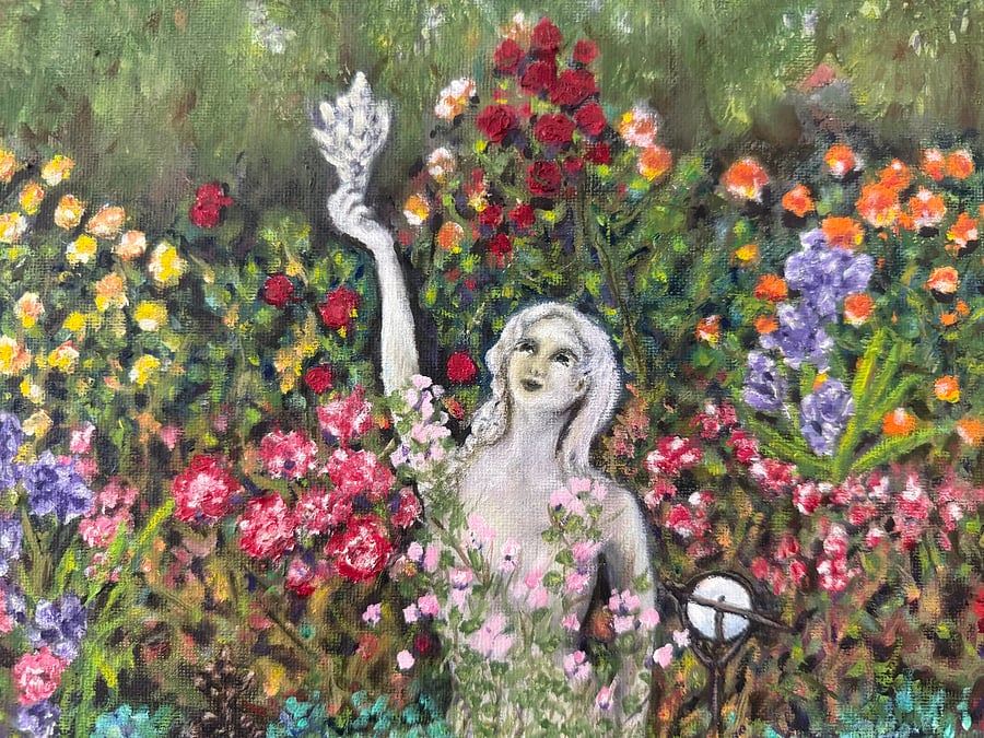 Lelani the mermaid is our mascot. This is a vintage painting of her who is in the garden outside.