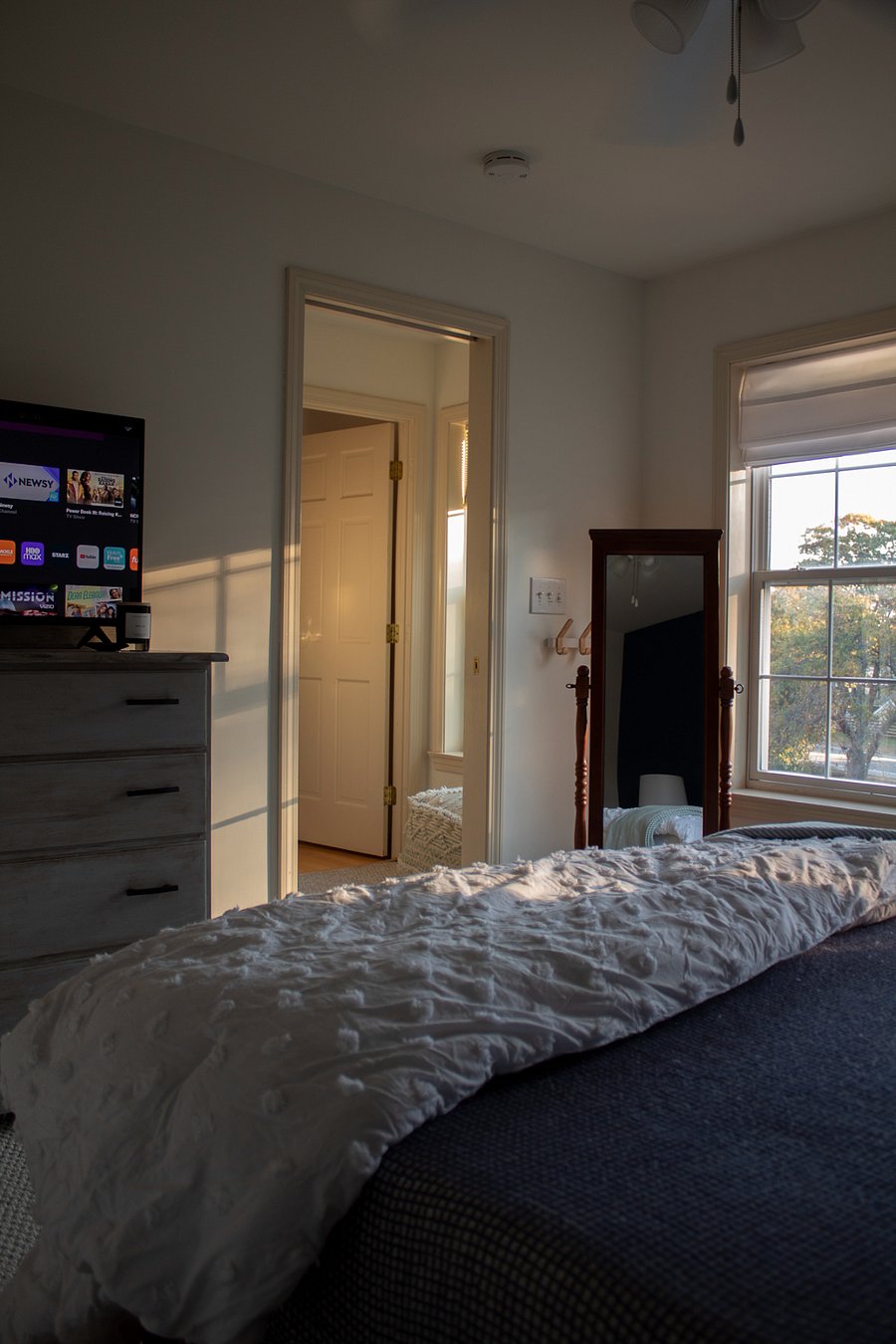 2nd floor front bedroom looking into the hall with smart TV and bureau