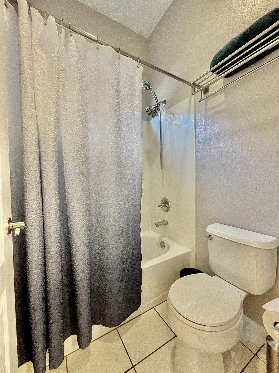 Bathtub and toilet is separated with door from the sink area