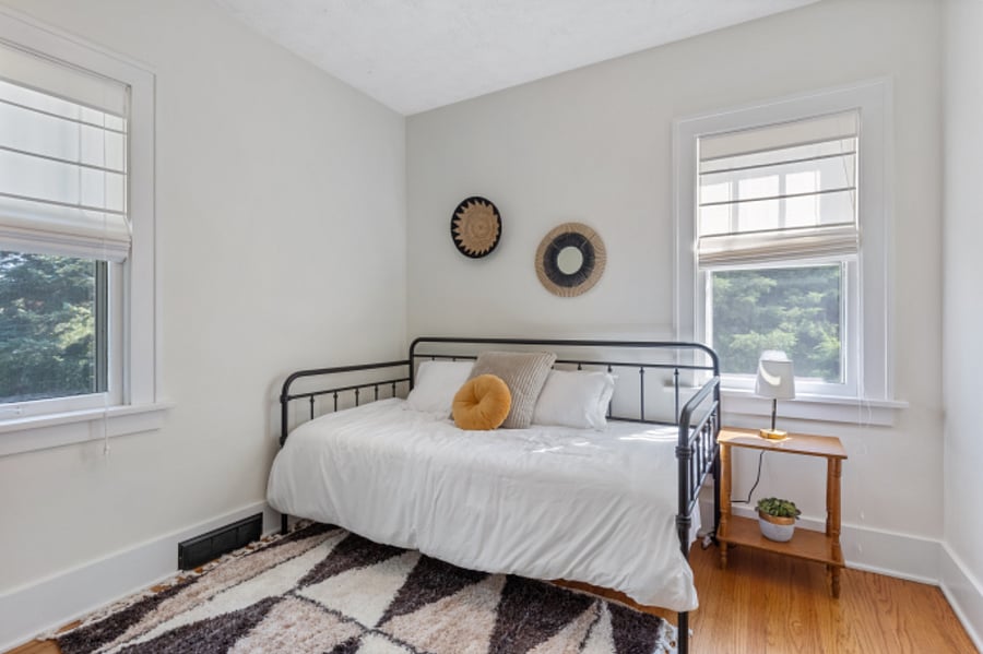 twin day bed, cozy bedding and an office space, extra closet space, hangers and storage shelves for dresser