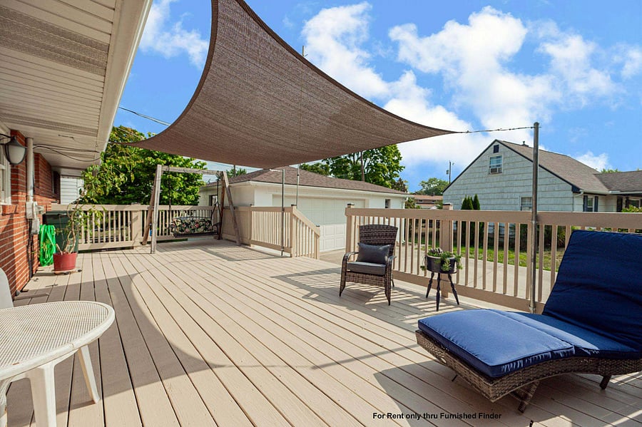 Sunny deck on east side by back door.