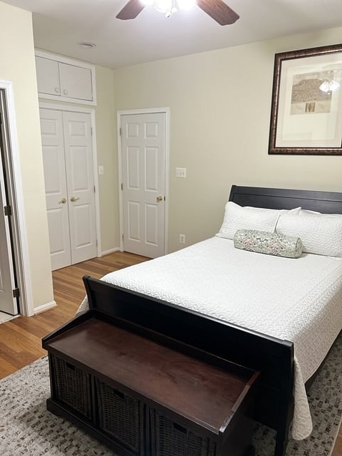 Rensselaer Room- full-size slay bed, hardwood floors, storage bench, bathroom, closet, and room entrance door.