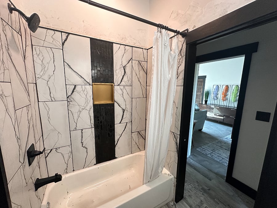 The shower is newly renovated and the sink is a double vanity for as much convenience as possible.