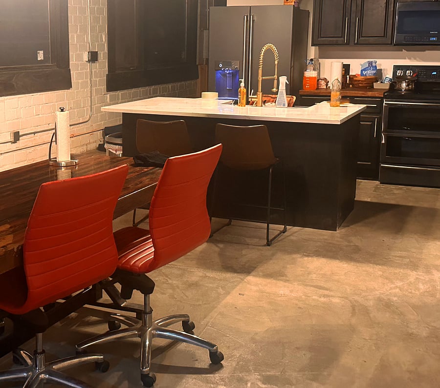 8 Foot dining table is between the kitchen and the living room.