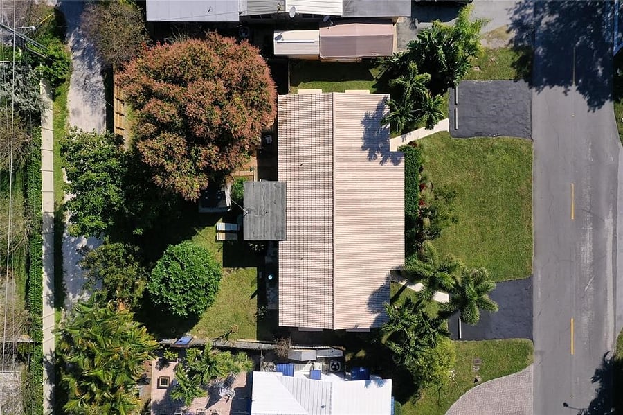 Drone photo of entire property 2061 and 2065 NE 68th Street: front driveways, the Duplex, and backyard with Mango and Avocado trees