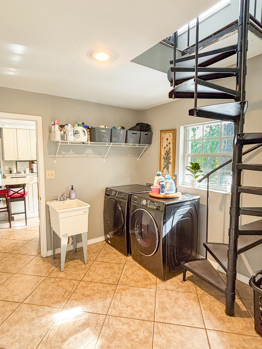 Full-size washer and dryer, utility sink, hanging space, iron and ironing board.