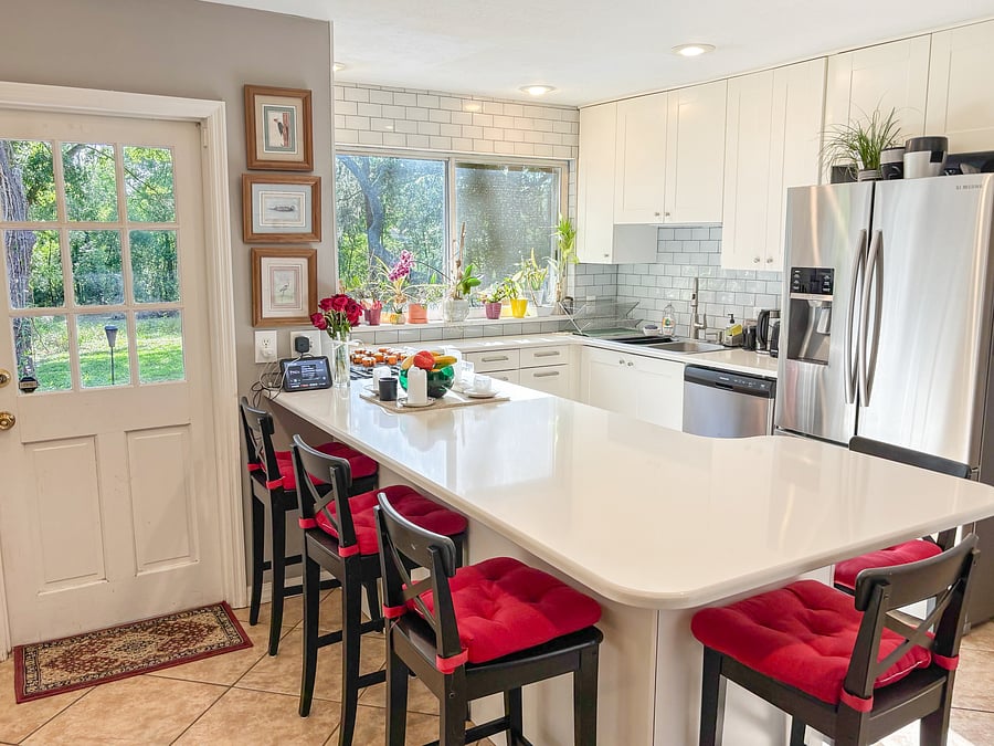 Spacious shared kitchen with breakfast-bar seating for five.