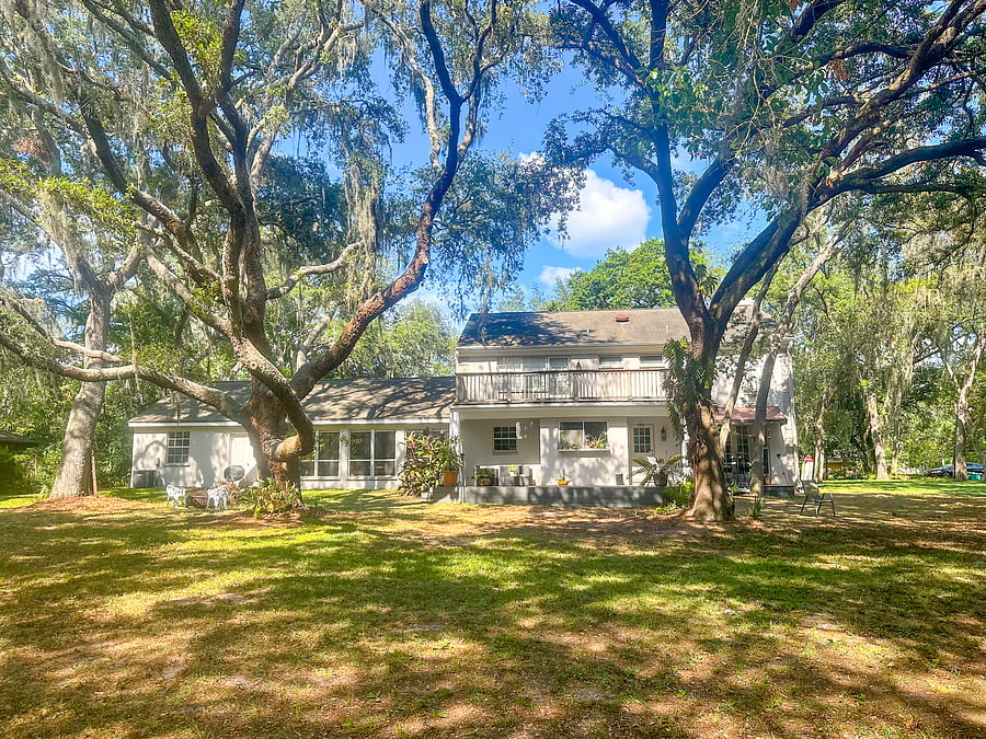 Relax outdoors on the deck overlooking the home's one-acre conservation lot.