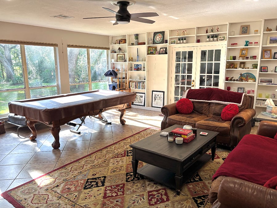 Shared family room includes large Smart tv, pool table, yoga space and workout equipment