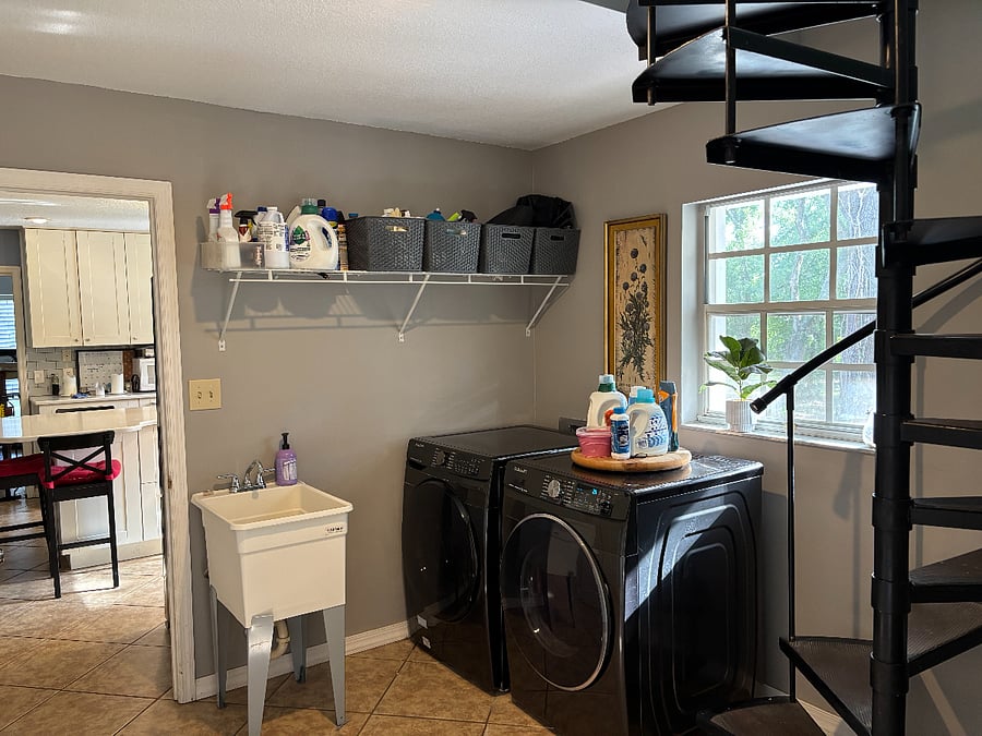 Laundry room with washer, dryer, laundry tub and hanging rack