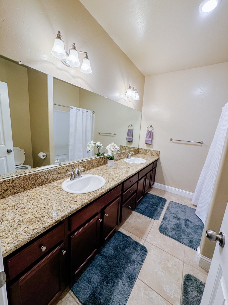 shared bathroom with dual sinks