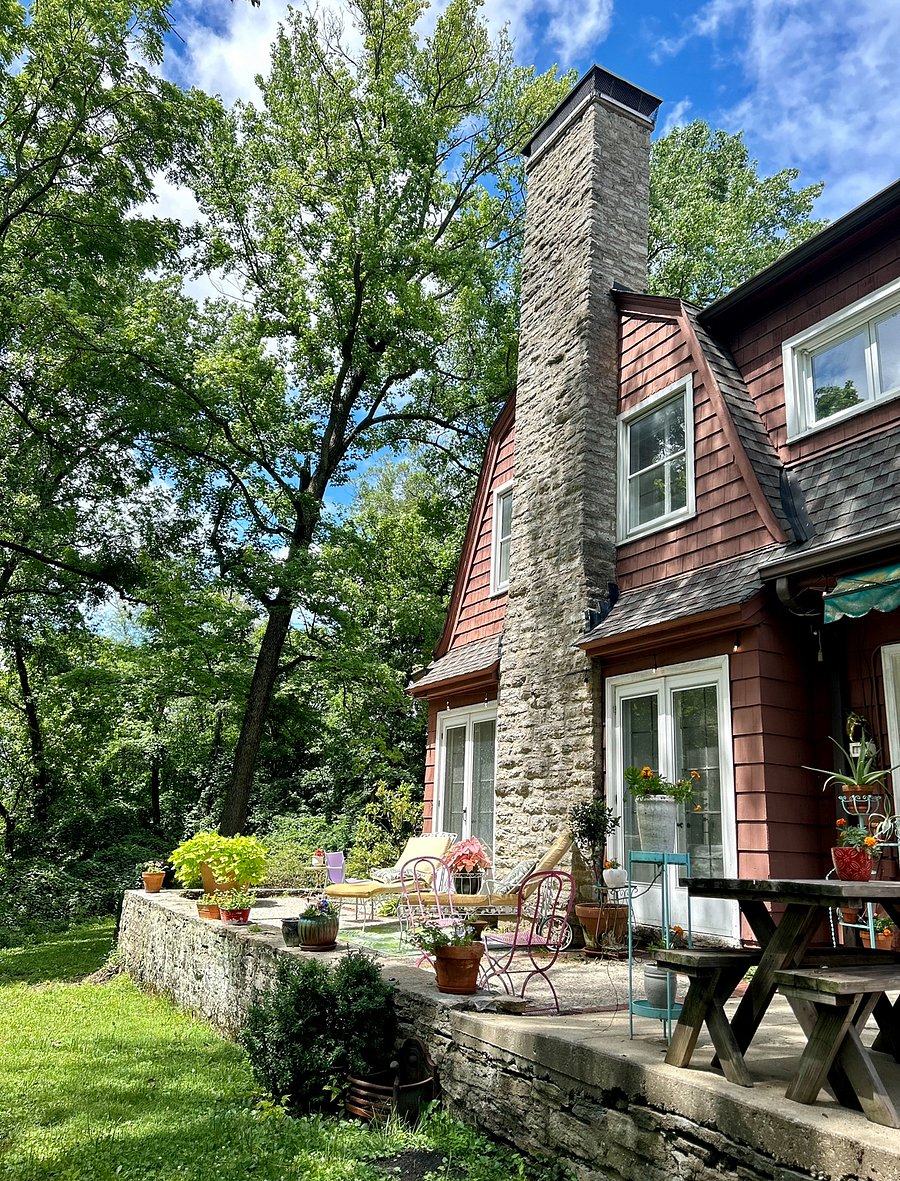 Serene patio with outdoor seating for guests to enjoy lush gardens, foliage, and fresh air. 