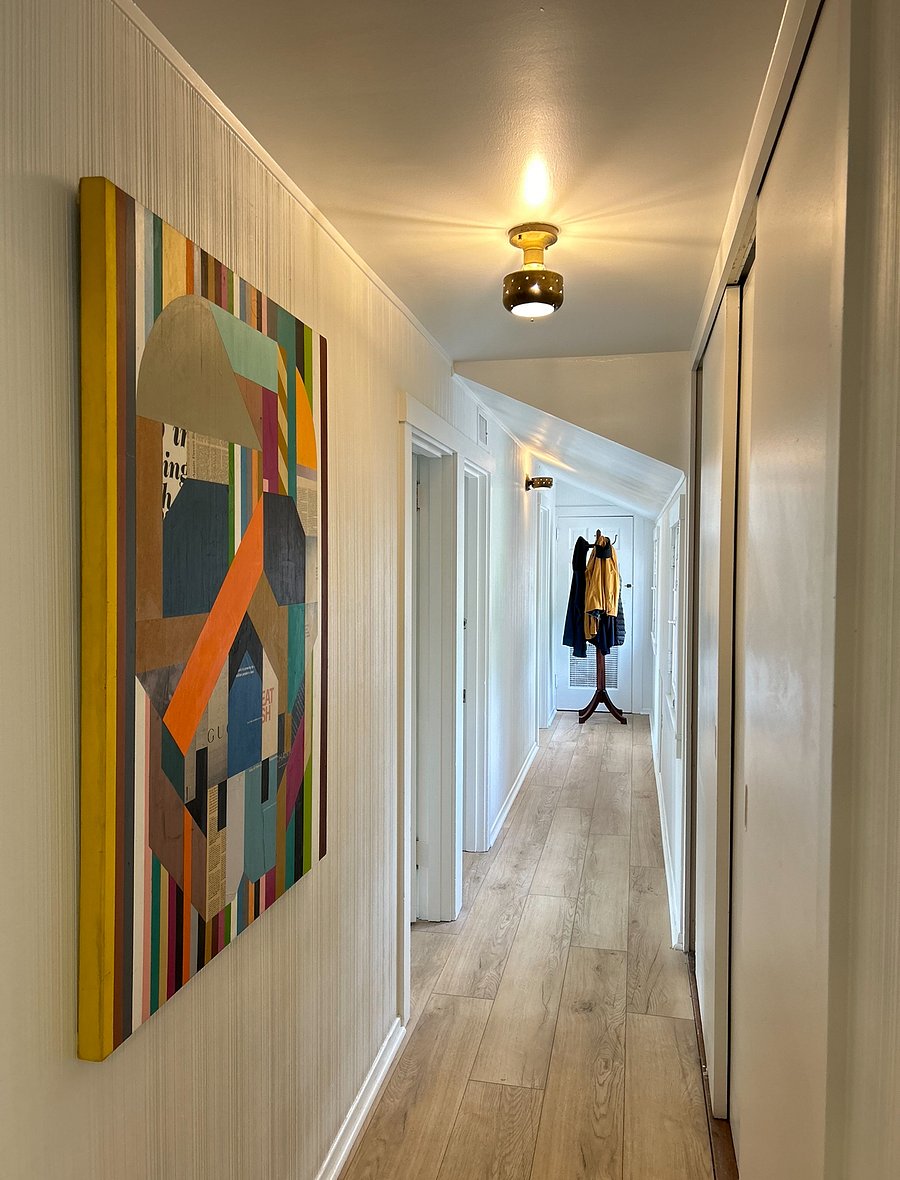 Hallway off of living space to bedrooms includes additional 2 full sliding-door closets for added storage. 