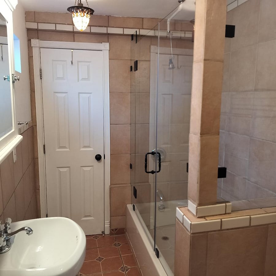 Fully tiled bath with full bath tub and shower, forced heat and air.
