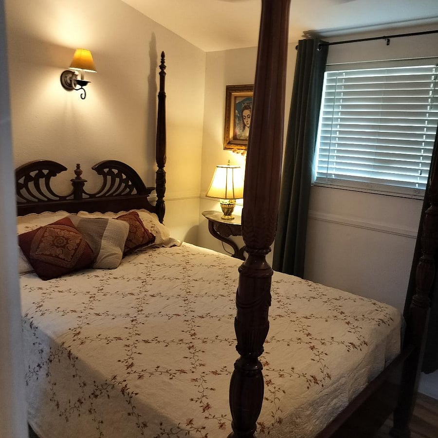 A Queen sized Victorian bed in this bedroom.