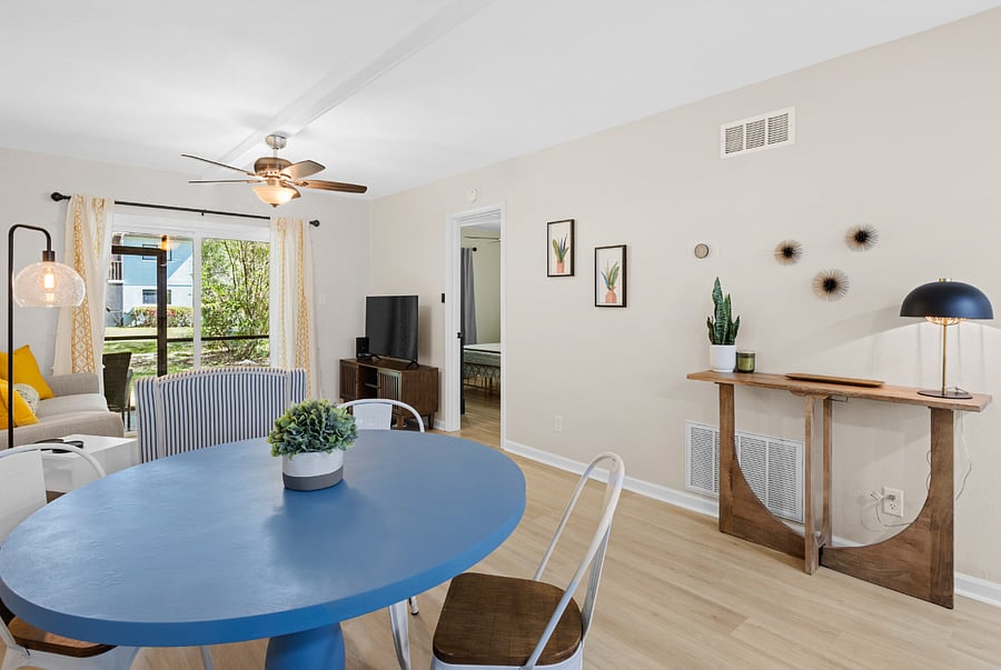 The dining area features a table with seating for four, seamlessly connected to the kitchen and living room, creating a welcoming space for meals and gatherings.
