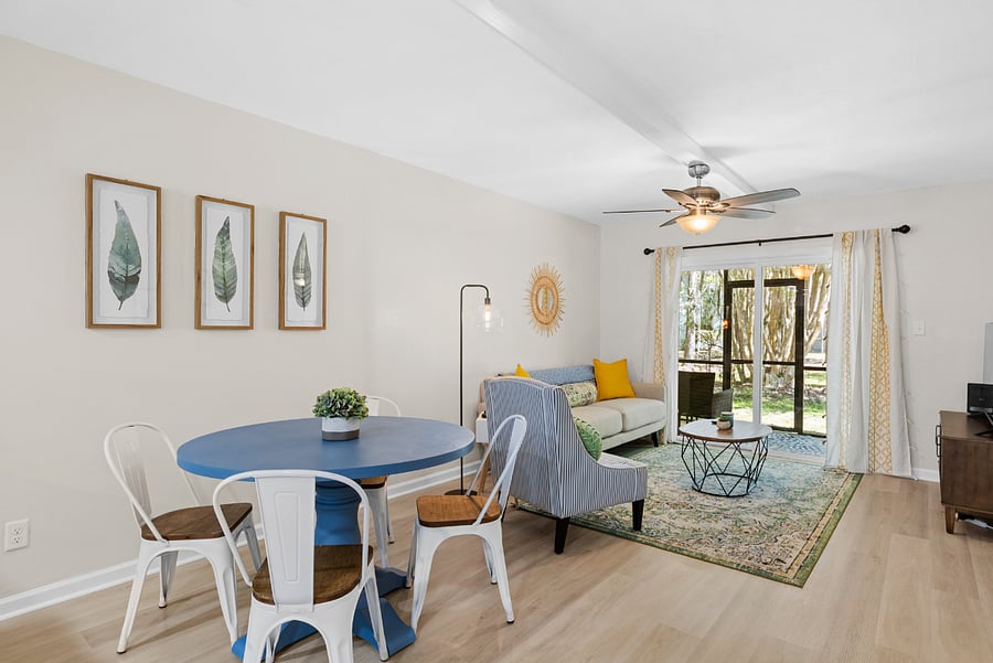 The dining area features a table with seating for four, seamlessly connected to the kitchen and living room, creating a welcoming space for meals and gatherings.