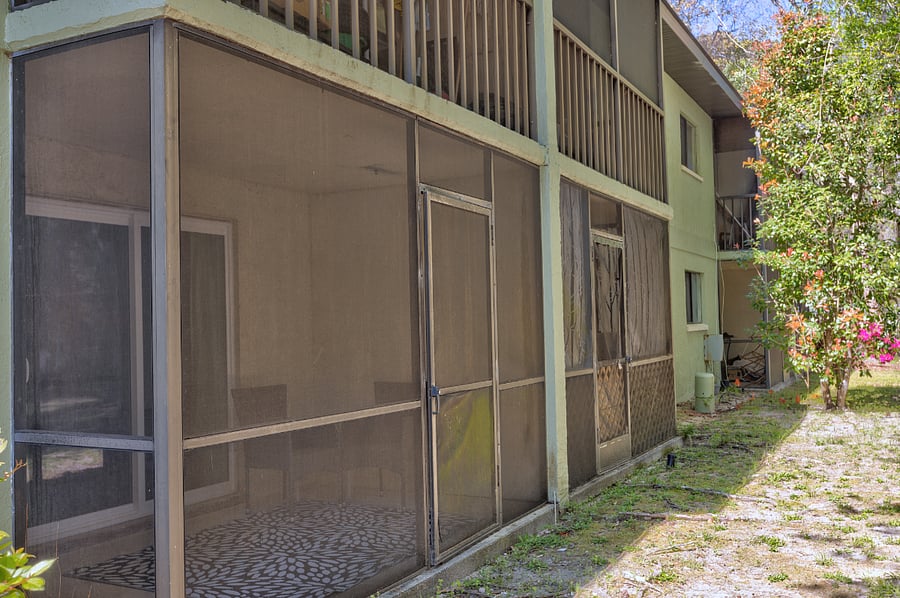 The private screened porch offers a comfortable seating area with a beautiful view of the surrounding outdoor landscape, perfect for relaxation and enjoying fresh air.