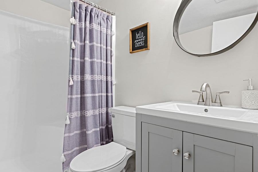 The full bathroom features a tub/shower combo, a vanity with a mirror, and includes all necessary towels, providing a convenient and relaxing space to get ready for the day or unwind in the evening.