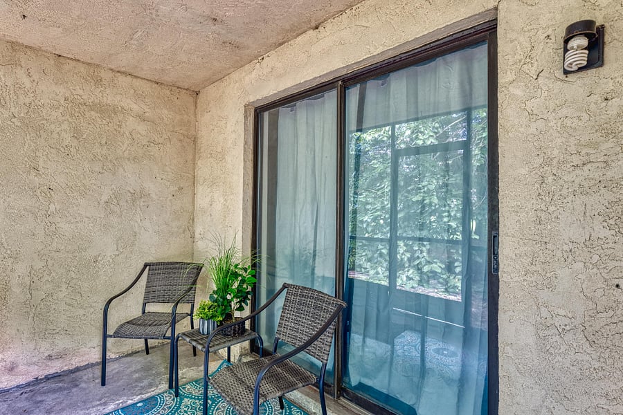 The screened porch offers a private, serene space with comfortable seating and beautiful views of the surrounding outdoor area, perfect for relaxation.






