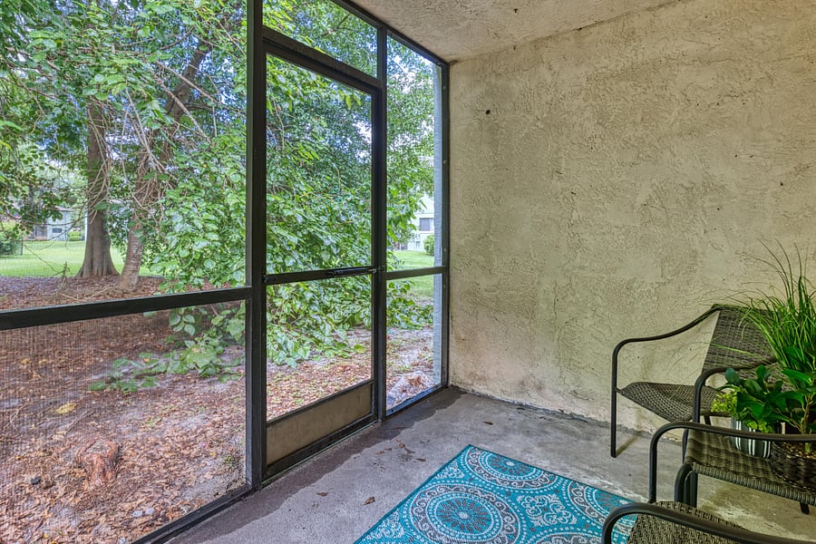 The screened porch offers a private, serene space with comfortable seating and beautiful views of the surrounding outdoor area, perfect for relaxation.






