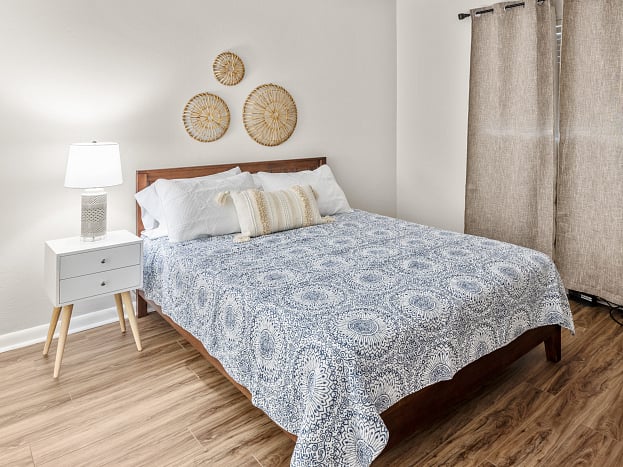 Bedroom 1 features a comfortable queen bed and is equipped with a smart TV, providing a cozy retreat for relaxation and entertainment.