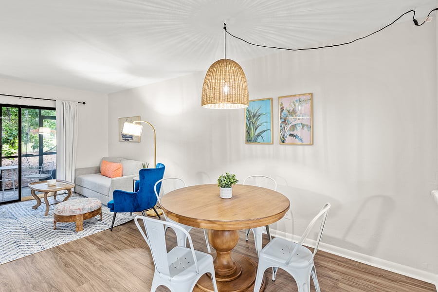 The dining area features a stylish table with seating for four, seamlessly connected to the kitchen for convenient and enjoyable meals.