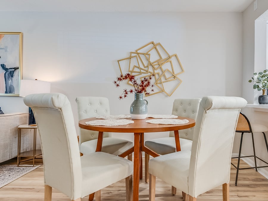 The dining area at Bluffside Charm offers versatility and comfort, with a stylish bar that seats two and a charming table with seating for four, making it perfect for both casual meals and intimate gatherings.