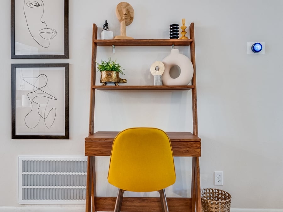 Bluffside Charms living room includes a dedicated workspace with a comfortable desk and chair, providing a quiet and convenient spot for productivity during your stay.