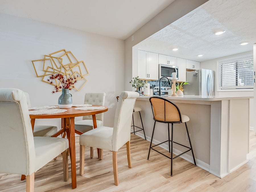 The dining area at Bluffside Charm offers versatility and comfort, with a stylish bar that seats two and a charming table with seating for four, making it perfect for both casual meals and intimate gatherings.