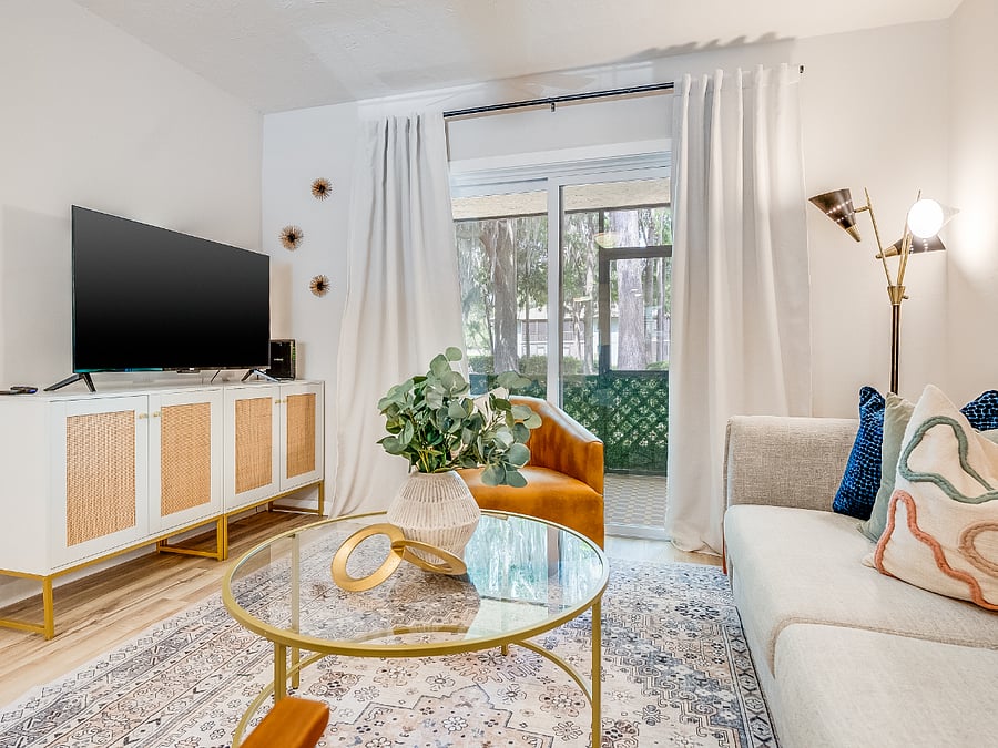 The living room at Bluffside Charm is a cozy haven, designed for relaxation and entertainment. It features plush seating, warm lighting, and a large smart TV, perfect for streaming your favorite shows or enjoying a movie night after a day of exploring Savannah.