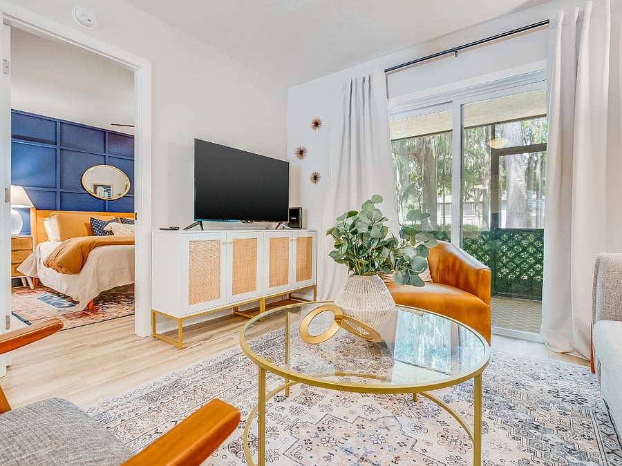The living room at Bluffside Charm is a cozy haven, designed for relaxation and entertainment. It features plush seating, warm lighting, and a large smart TV, perfect for streaming your favorite shows or enjoying a movie night after a day of exploring Savannah.