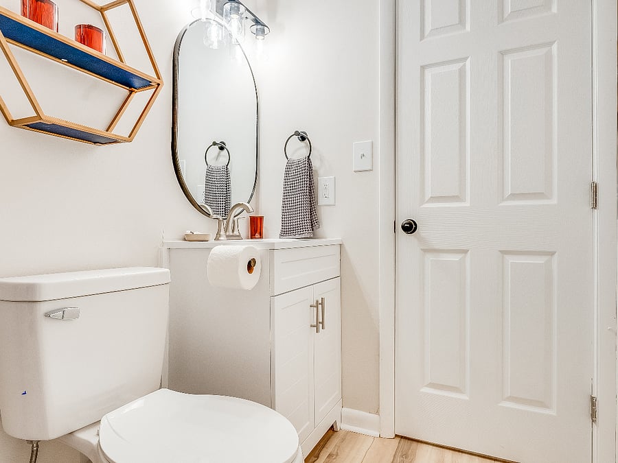 The ensuite full bathroom in the primary bedroom at Bluffside Charm is fully equipped with fresh towels and a hairdryer, ensuring you have everything you need for a comfortable and convenient stay.