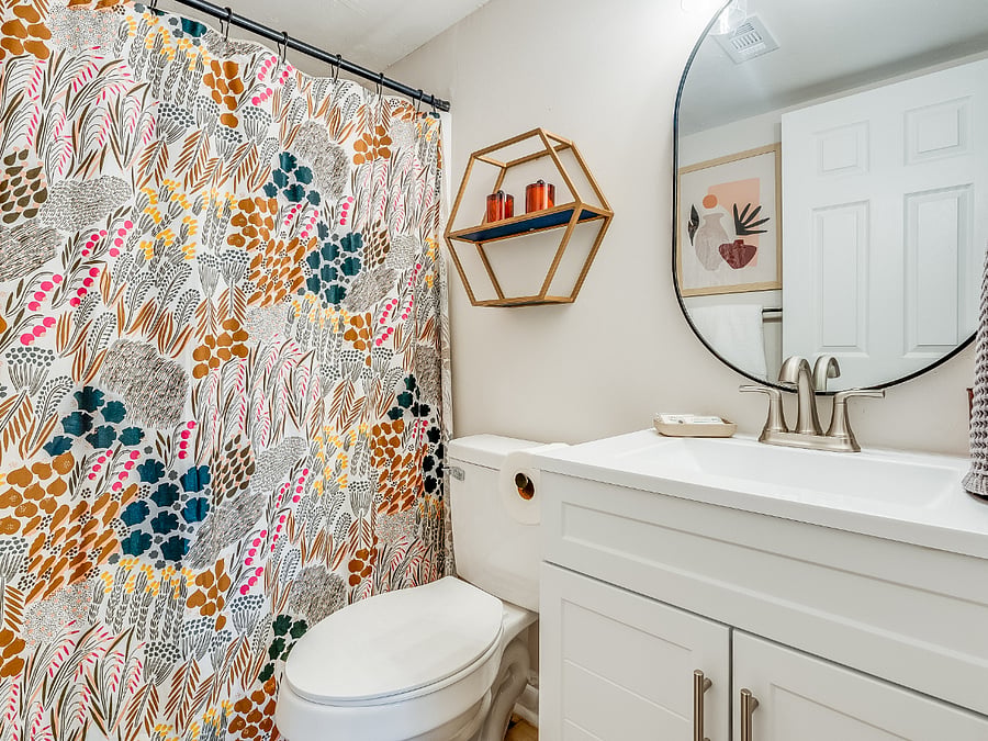 The ensuite full bathroom in the primary bedroom at Bluffside Charm is fully equipped with fresh towels and a hairdryer, ensuring you have everything you need for a comfortable and convenient stay.