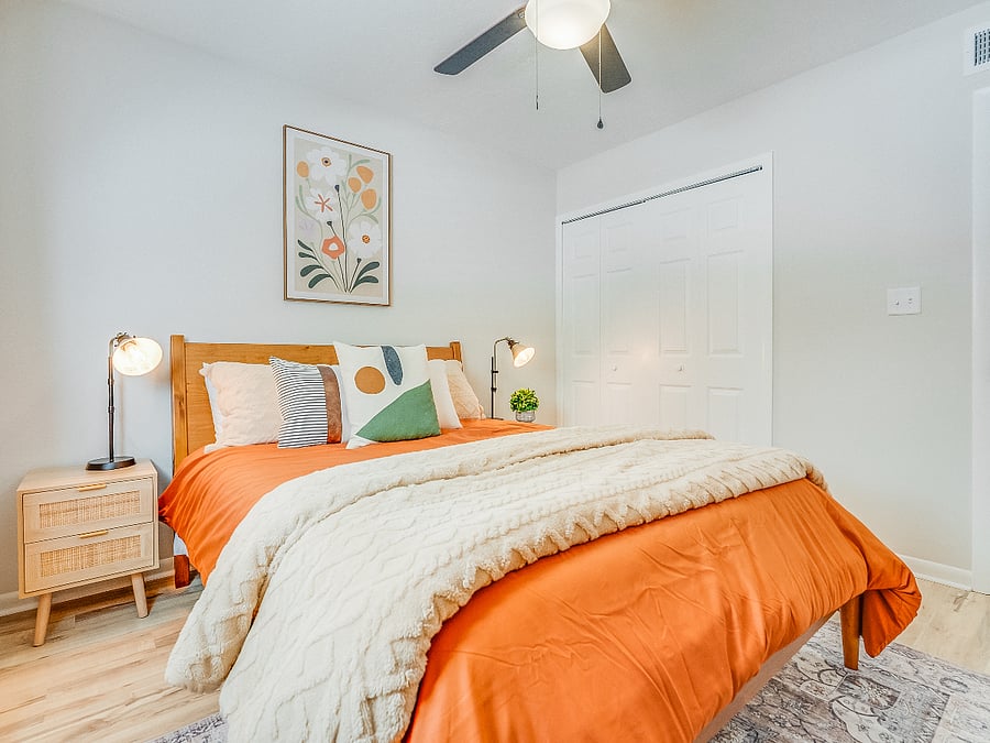 The second bedroom at Bluffside Charm offers a cozy and private retreat, featuring a comfortable queen bed, its own private bath, and a smart TV. 