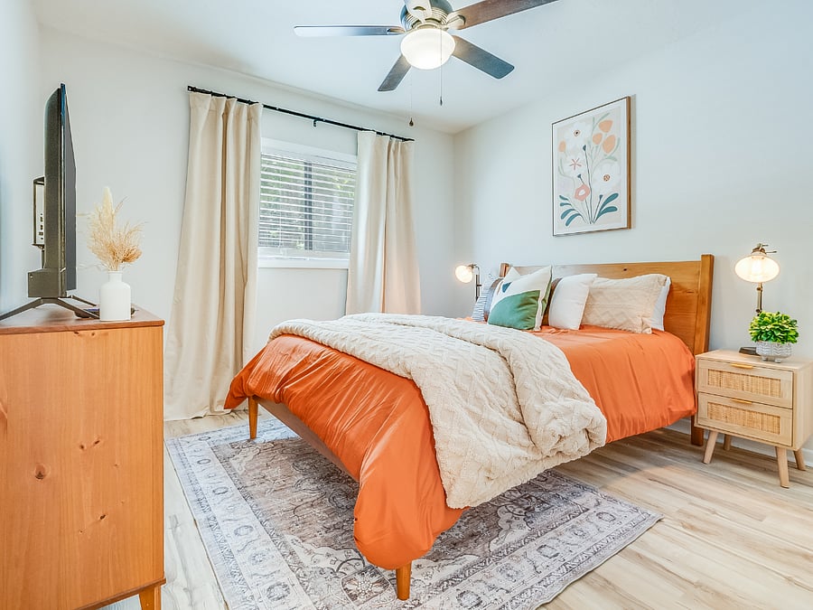 The second bedroom at Bluffside Charm offers a cozy and private retreat, featuring a comfortable queen bed, its own private bath, and a smart TV. 