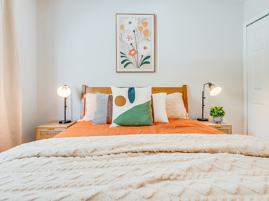The second bedroom at Bluffside Charm offers a cozy and private retreat, featuring a comfortable queen bed, its own private bath, and a smart TV. 