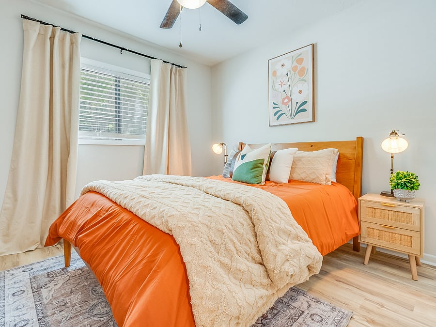 The second bedroom at Bluffside Charm offers a cozy and private retreat, featuring a comfortable queen bed, its own private bath, and a smart TV. 