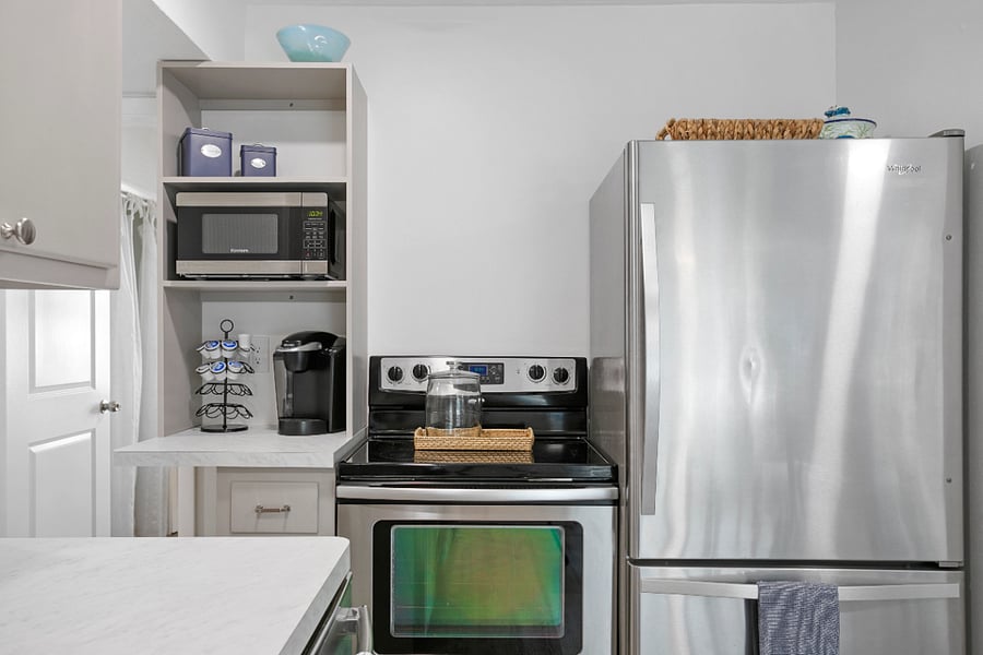 Kitchen includes refrigerator with bottom freezer, stove, dishwasher, microwave and Keurig coffeemaker.