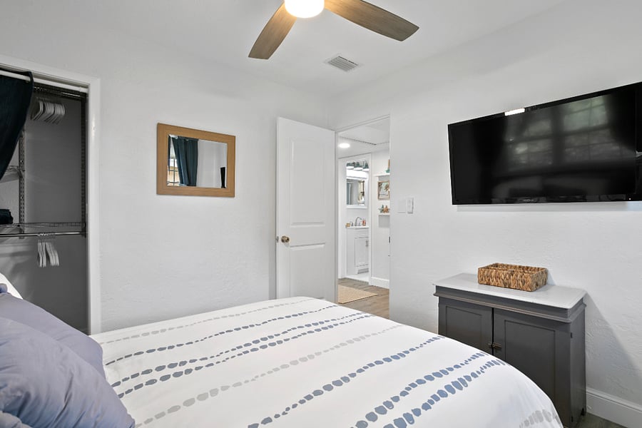 Downstairs- Bedroom2 - Full bed. Includes room darkening curtains, vertical blinds and smart tv.