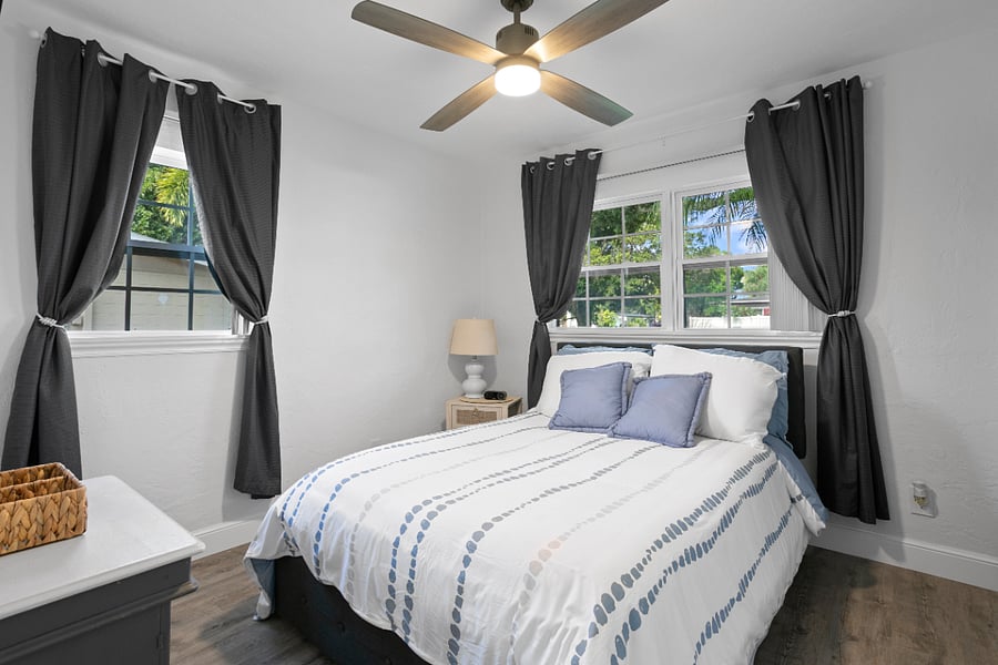 Downstairs- Bedroom2 - Full bed. Includes room darkening curtains, vertical blinds and smart tv.
