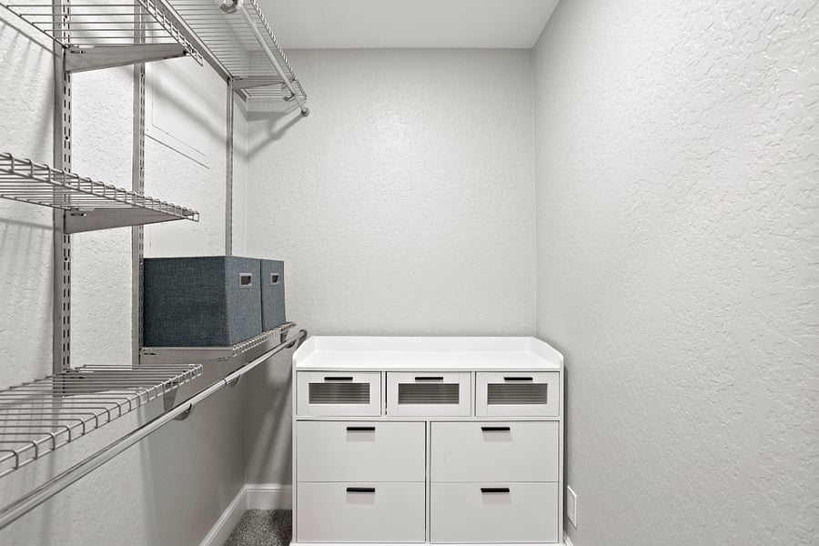 Large Walk-In Closet with dresser.